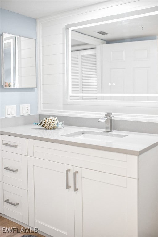 bathroom with vanity and hardwood / wood-style floors