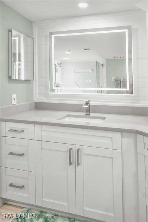 bathroom featuring a tub to relax in and vanity