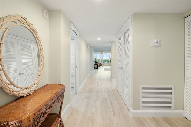 hall with light hardwood / wood-style floors