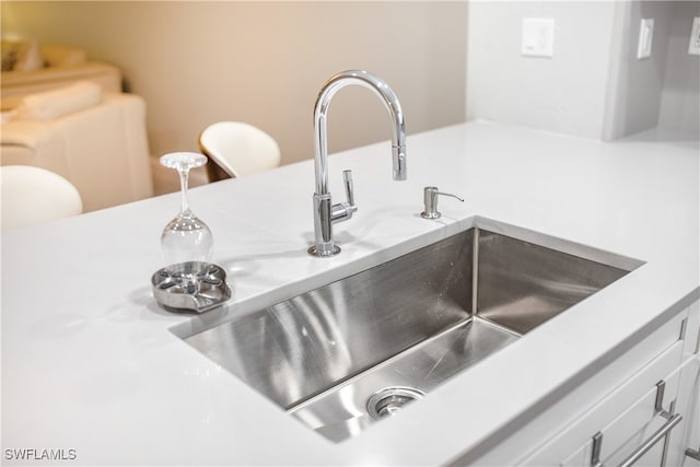 interior details with sink and white cabinets