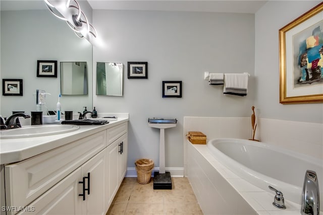 bathroom featuring tiled tub, vanity, and tile patterned flooring