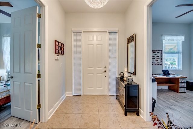 tiled entrance foyer with ceiling fan