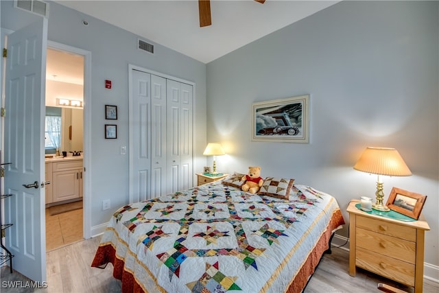 bedroom with ceiling fan, connected bathroom, a closet, and light wood-type flooring