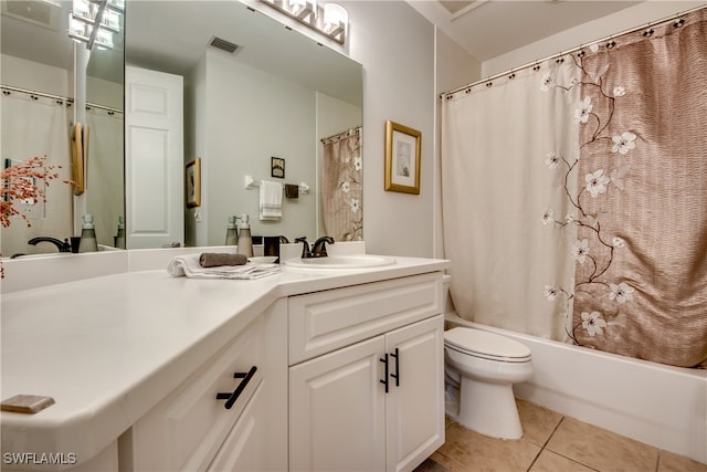 full bathroom featuring vanity, tile patterned floors, toilet, and shower / bath combo