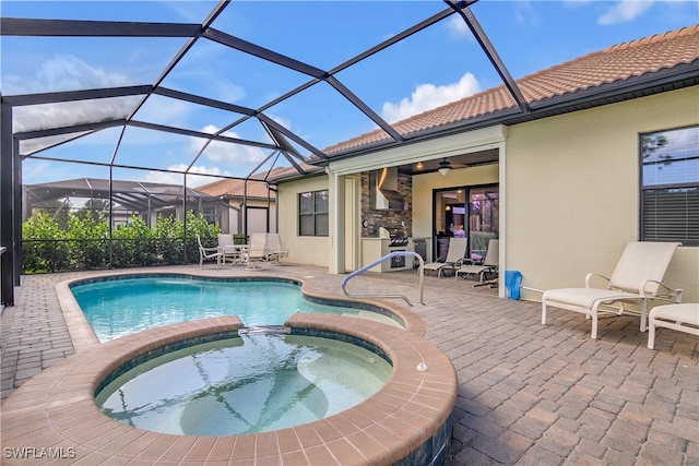 view of swimming pool featuring a lanai, ceiling fan, a patio area, and an in ground hot tub