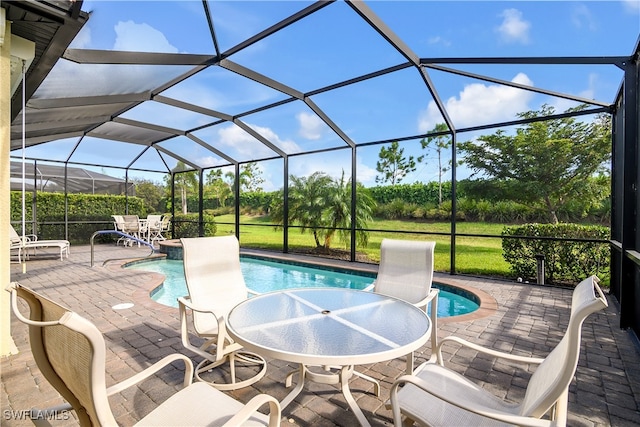 view of pool with a patio and glass enclosure