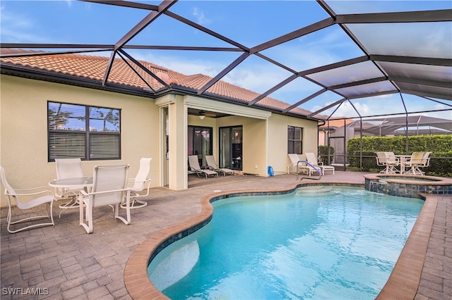 view of pool featuring an in ground hot tub, a patio, ceiling fan, and a lanai