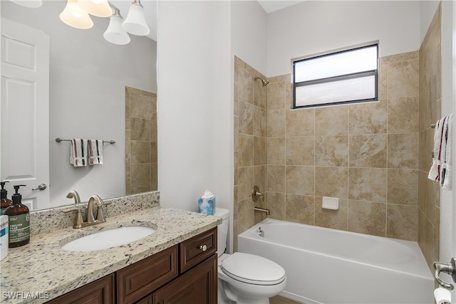 full bathroom with tiled shower / bath combo, toilet, and vanity