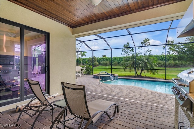 view of swimming pool with a lanai, a patio area, and a grill