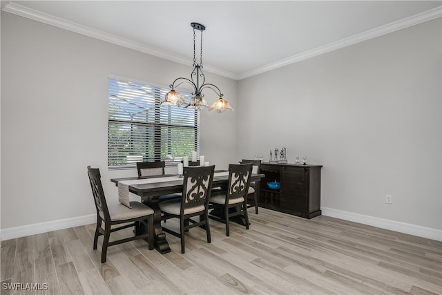 dining space with light hardwood / wood-style floors, a notable chandelier, and ornamental molding