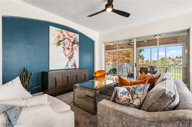 living room featuring a water view and crown molding