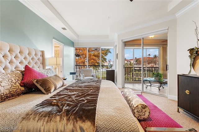 bedroom featuring access to outside, a tray ceiling, and ornamental molding