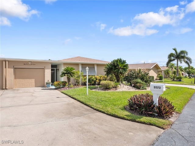 ranch-style home featuring a front lawn and a garage