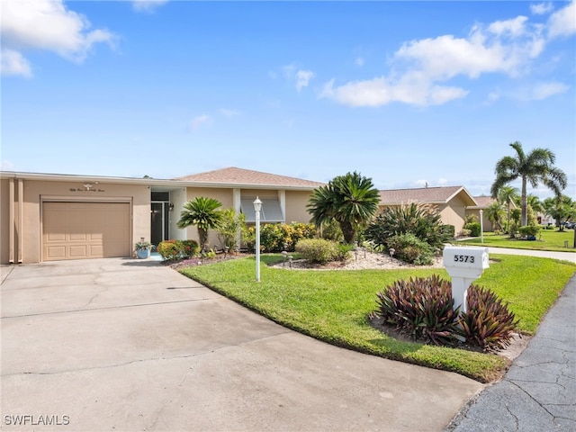 view of front facade featuring stucco siding, driveway, a front yard, and an attached garage