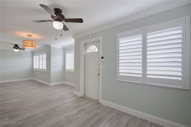 foyer featuring ceiling fan, light wood-type flooring, and ornamental molding