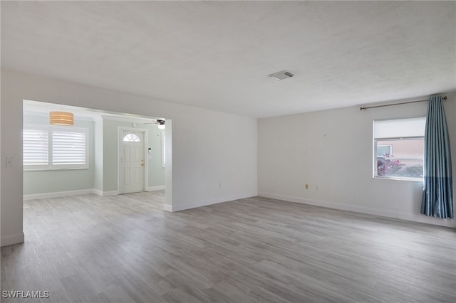 unfurnished room featuring light hardwood / wood-style flooring and ceiling fan