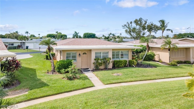 ranch-style home with a front lawn