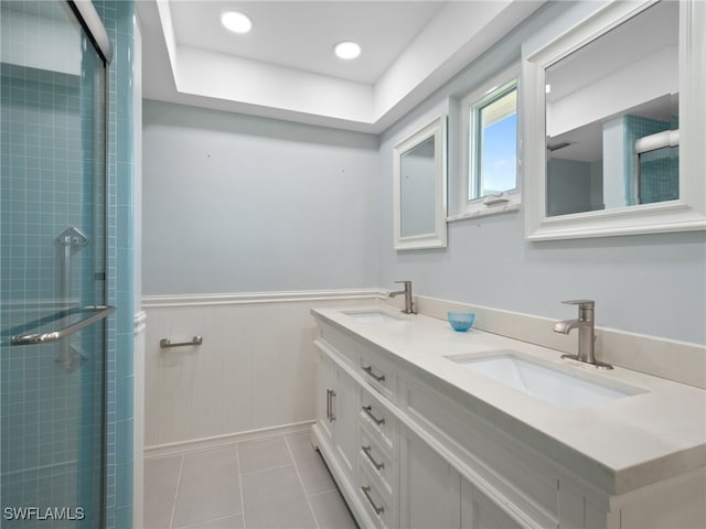 bathroom with tile patterned floors, vanity, and a shower with shower door