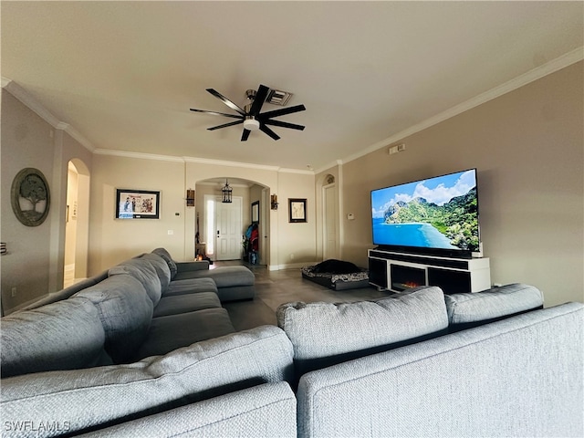 carpeted living room featuring ceiling fan, a fireplace, and crown molding