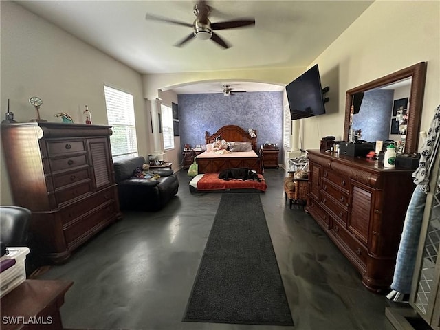 bedroom with decorative columns and ceiling fan