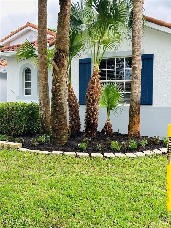 view of side of home featuring a yard