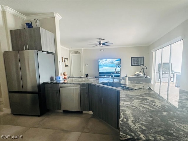 kitchen featuring sink, crown molding, stone counters, ceiling fan, and stainless steel appliances