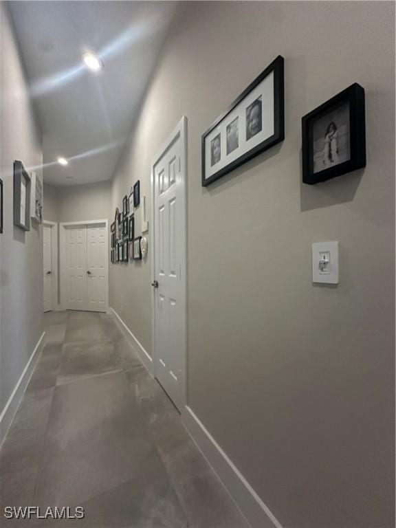 hallway with concrete flooring