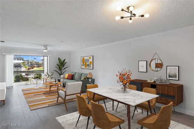 dining space featuring a textured ceiling, crown molding, and a chandelier