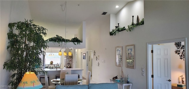 living room featuring a high ceiling and an inviting chandelier