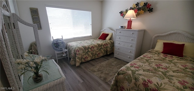 bedroom with dark hardwood / wood-style floors