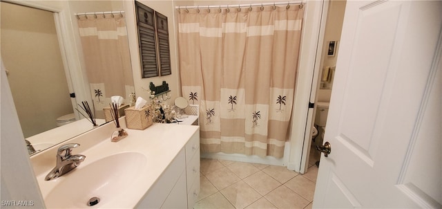 bathroom with vanity, tile patterned flooring, and toilet