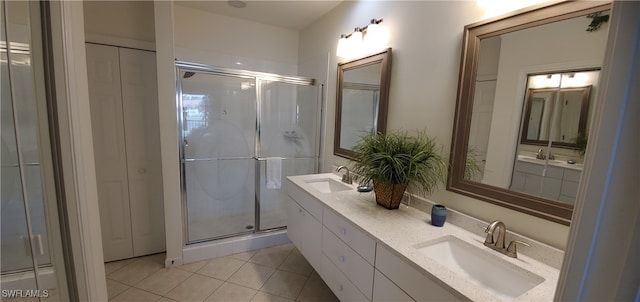 bathroom featuring tile patterned flooring, walk in shower, and vanity