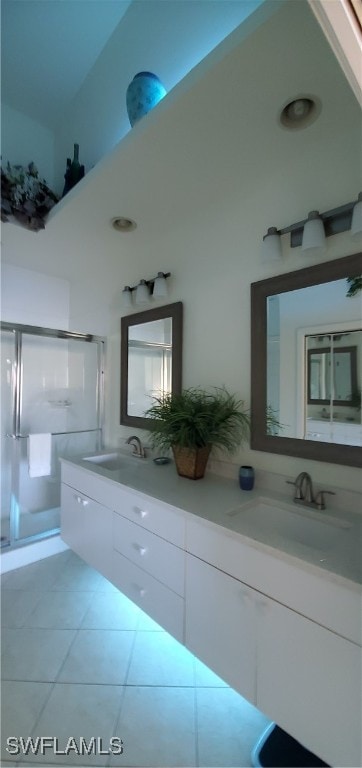 bathroom featuring vanity, a shower with shower door, and tile patterned floors