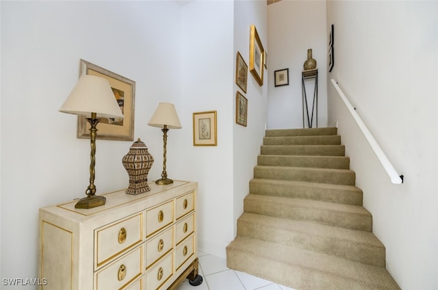 stairway with tile patterned floors