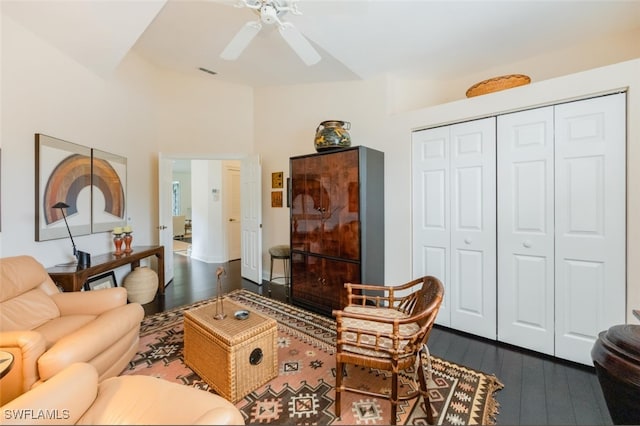 living area with dark wood-style flooring, visible vents, and ceiling fan