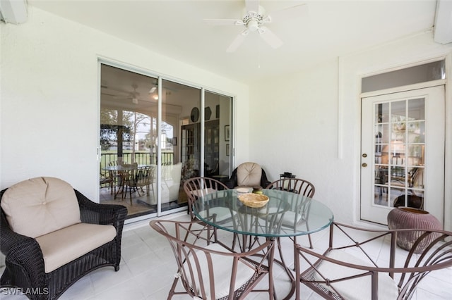 sunroom / solarium featuring ceiling fan