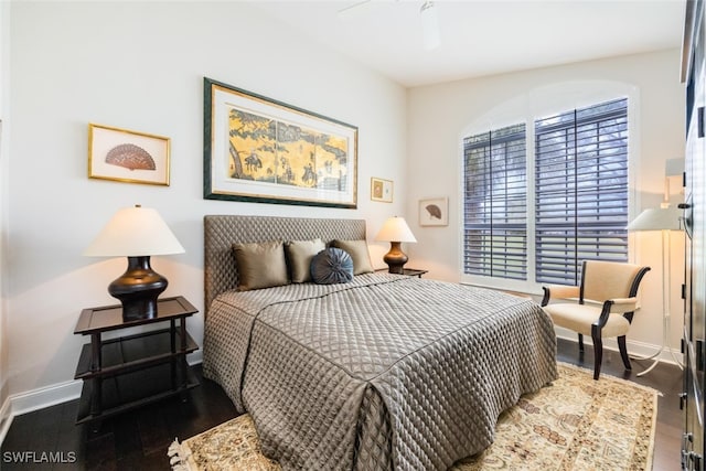 bedroom featuring wood finished floors and baseboards