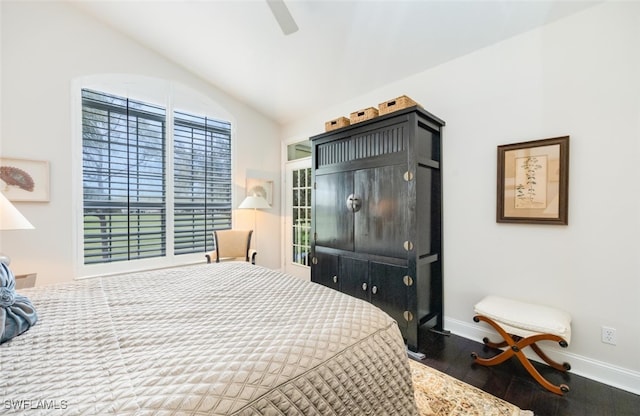 bedroom with lofted ceiling, ceiling fan, wood finished floors, and baseboards