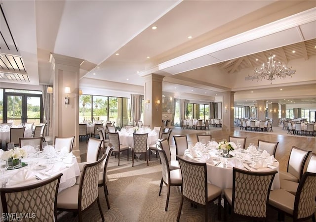 dining space featuring recessed lighting, french doors, a notable chandelier, and ornate columns