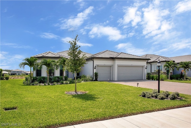 view of front of property featuring a front yard and a garage