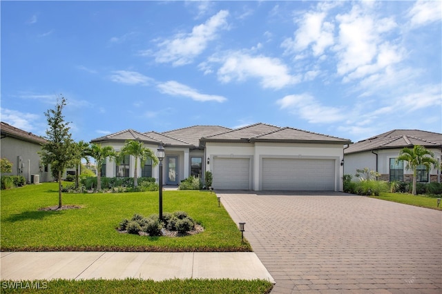 view of front of house featuring a front yard and a garage