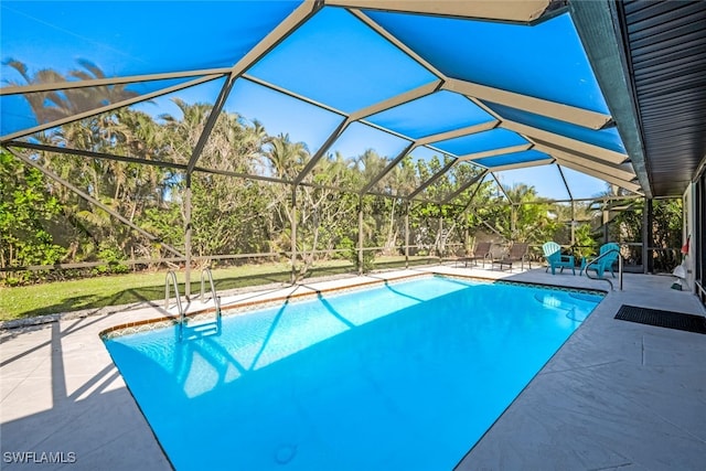 view of swimming pool featuring a lanai and a patio area