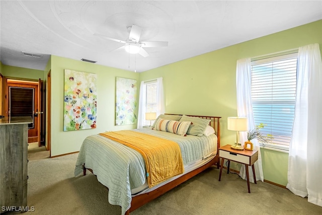 bedroom featuring ceiling fan and light carpet