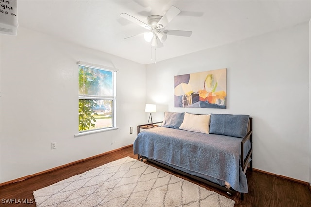 bedroom with ceiling fan and hardwood / wood-style flooring