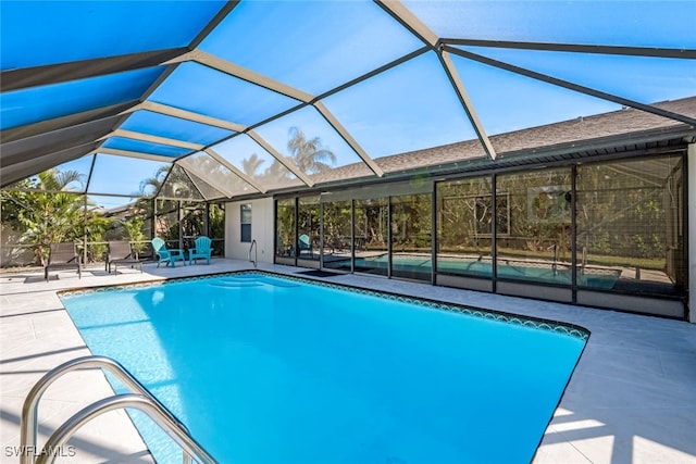 view of pool featuring a lanai and a patio