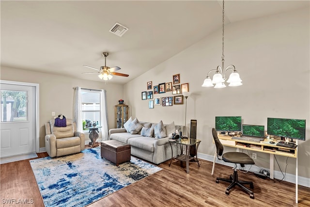 living room with hardwood / wood-style flooring, vaulted ceiling, and ceiling fan with notable chandelier