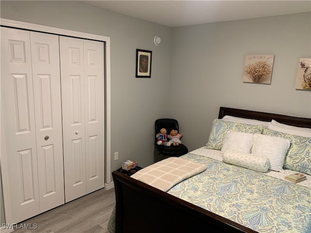 bedroom featuring light hardwood / wood-style flooring and a closet