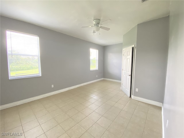 empty room with light tile patterned flooring and ceiling fan