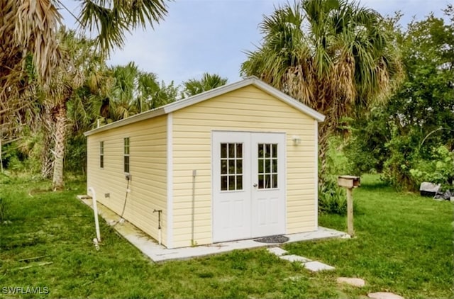 view of outbuilding featuring a lawn