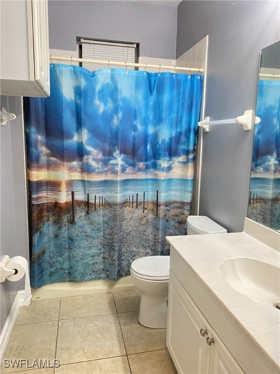 bathroom featuring curtained shower, vanity, toilet, and tile patterned floors